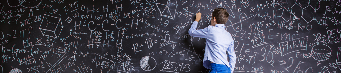 boy writing on a huge chalkboard